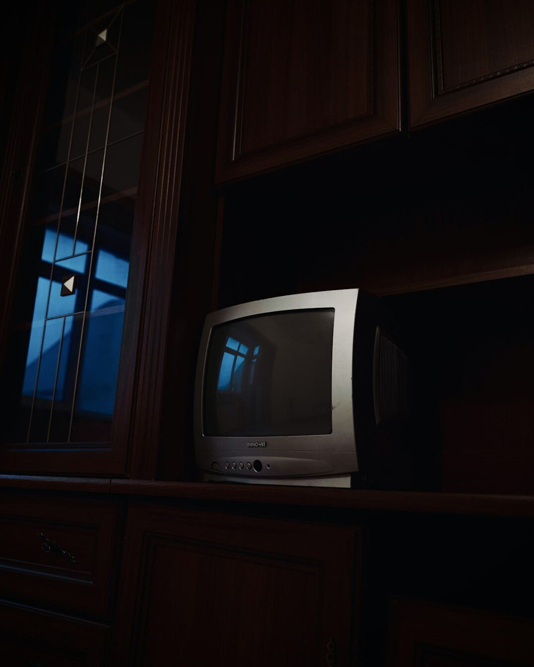 Vintage wooden cabinet television set with a glowing CRT screen