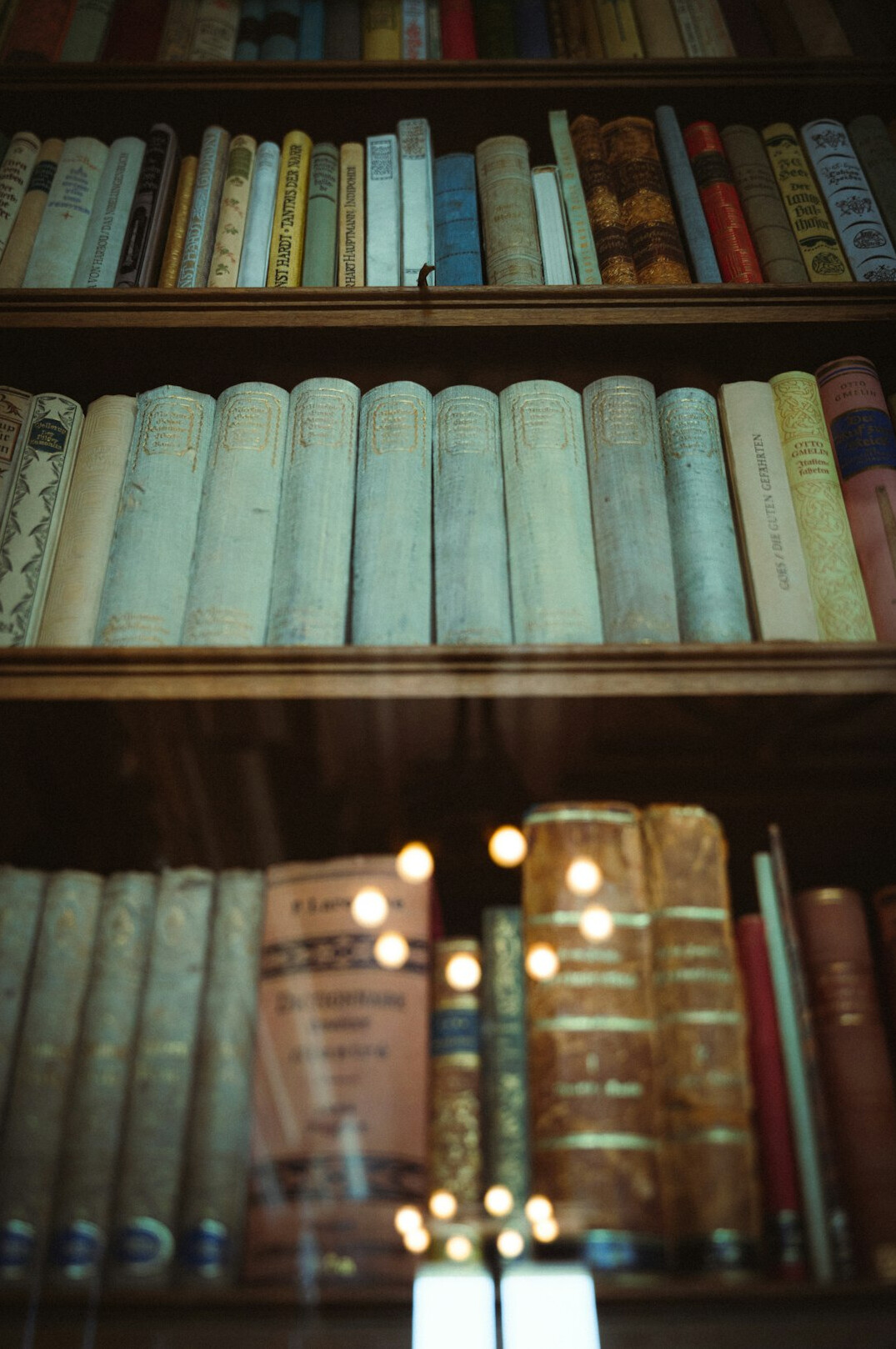 Old books on a shelf in warm light