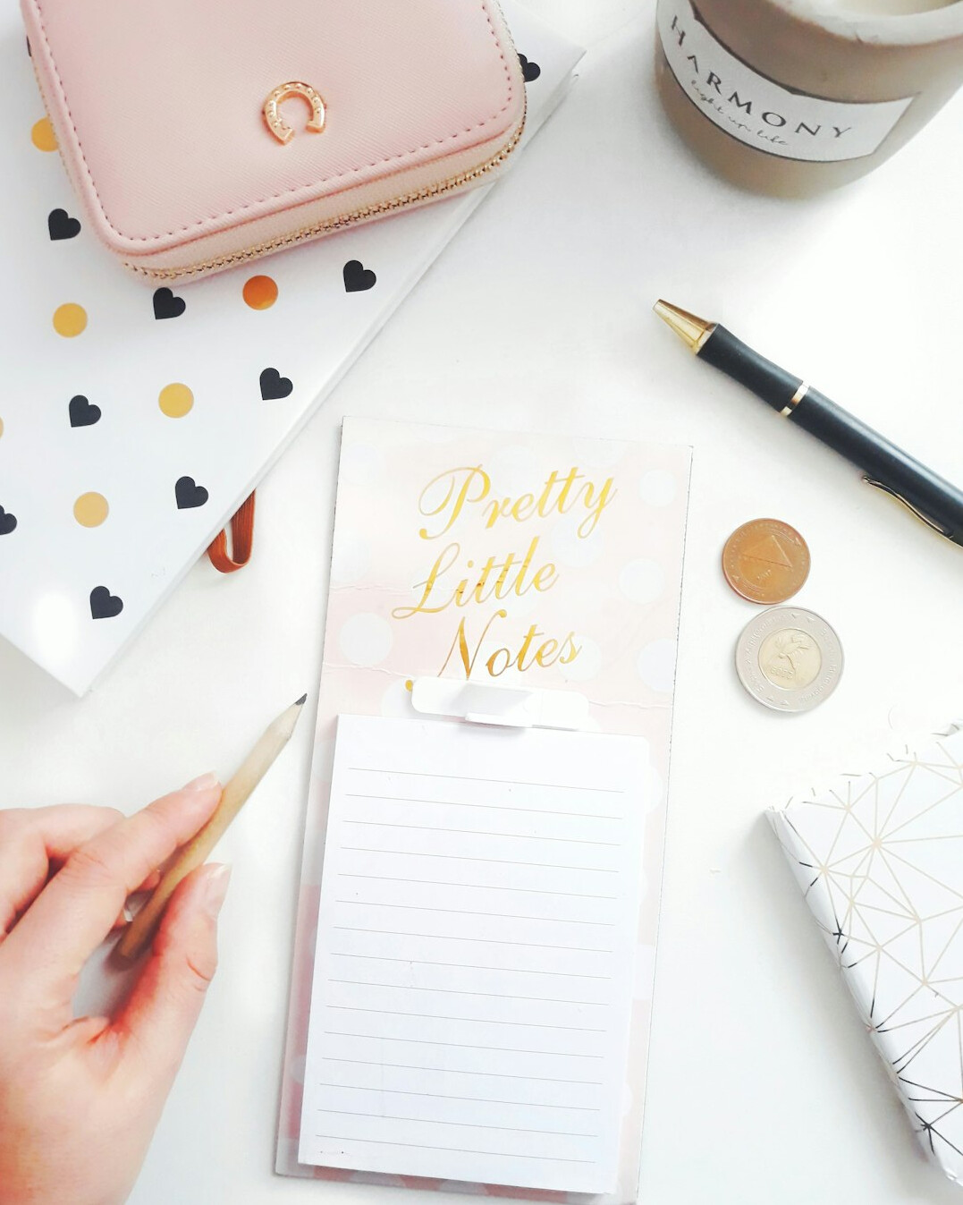 Hand writing notes in a notebook with a pen