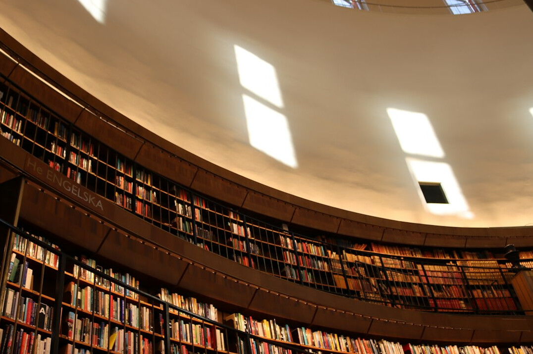 Library reading room with tall wooden bookshelves