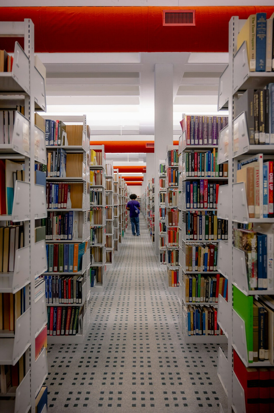 Quiet library aisle with bookshelves on both sides